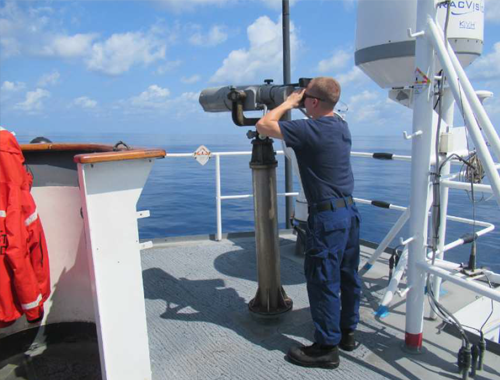 A crewmember stands Lookout watch underway.